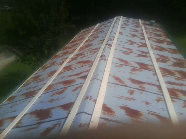 Rusted metal roof panels with new wood purlins before replacement — Storm Damage Roof Repair in Schodack Landing by Roofing Brothers