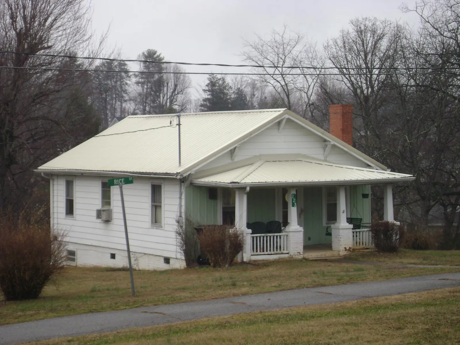 White metal roof on a craftsman bungalow at a street corner in Schodack Landing